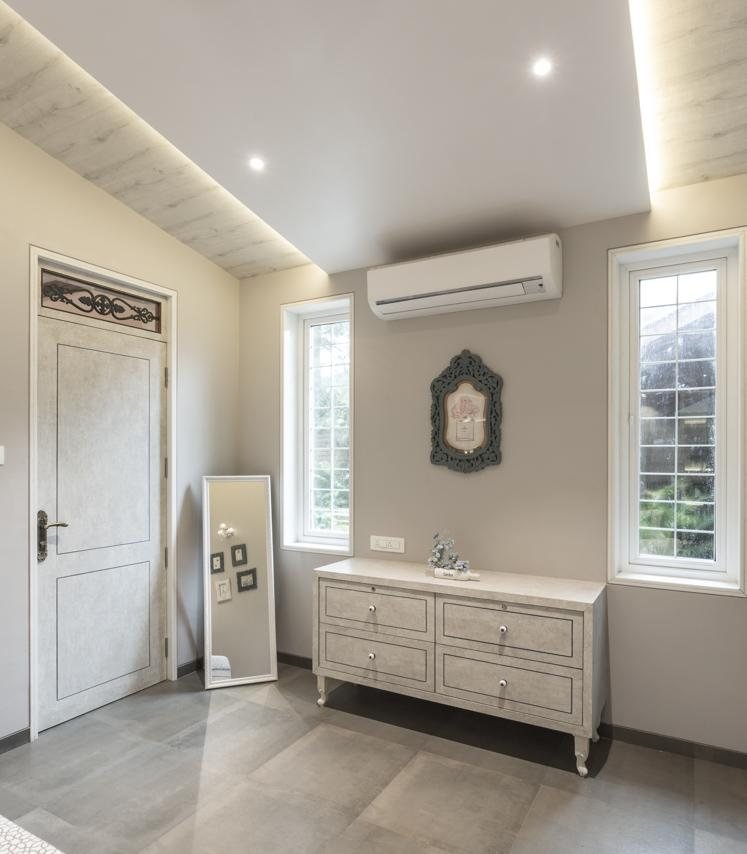 Farmhouse bathroom with a freestanding white bathtub and ornate mirror