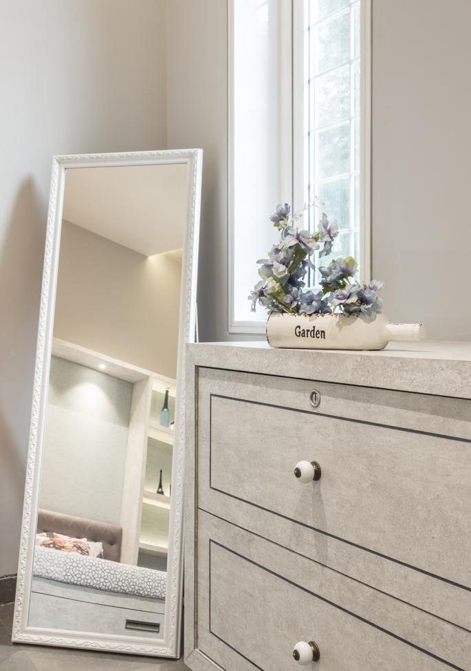 Farmhouse bathroom vanity detail with dresser and mirror