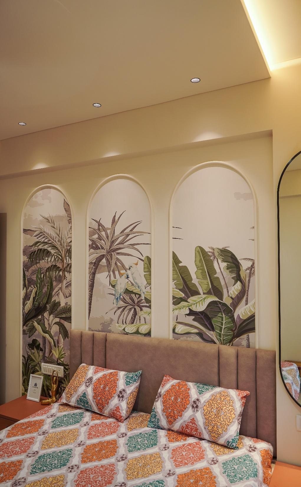 Karpe Residence bedroom in Sawantwadi with arched tropical botanical wallpaper panels above the headboard