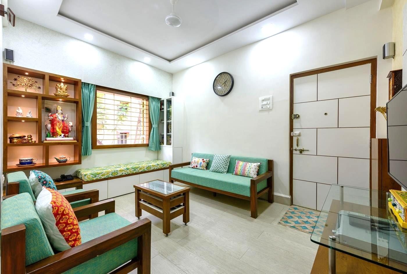 Living room in Thane with a traditional mandir display unit and mint-green sofa seating