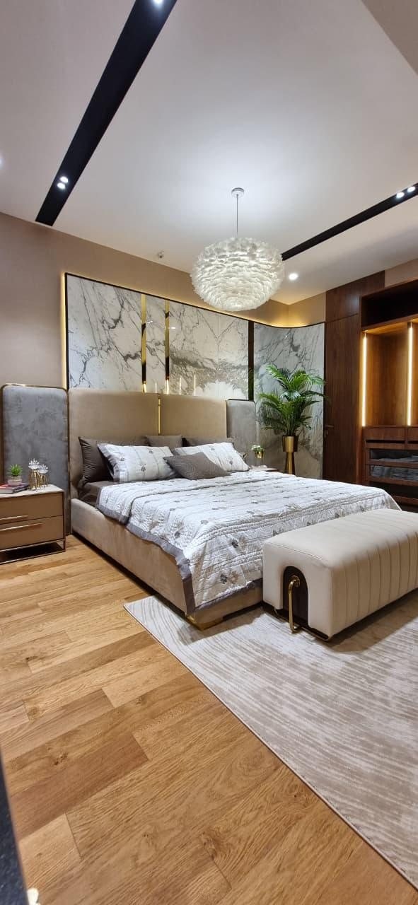 Show flat bedroom at Ruparel Jewels, Parel, with a red accent bed