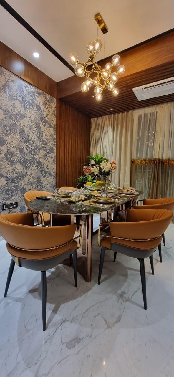 Show flat living room at Ruparel Jewels, Parel, with a burnt-orange sofa and mustard accent chair