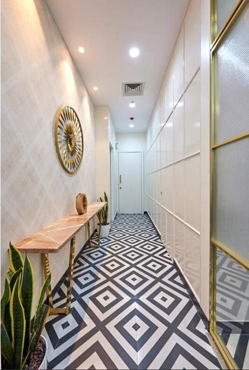 Sethwala Food Solutions office corridor with patterned flooring and gold-trimmed cabinetry