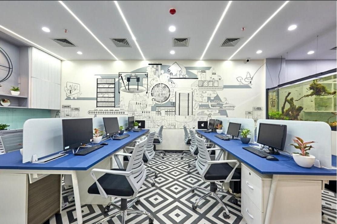 Sethwala Food Solutions open workstation area with an illustrated feature wall